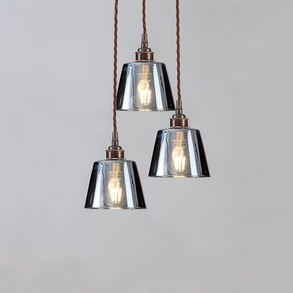 Three Blown Smoked Glass Cluster Pendant Lights by Old School Electric hanging on a white background.