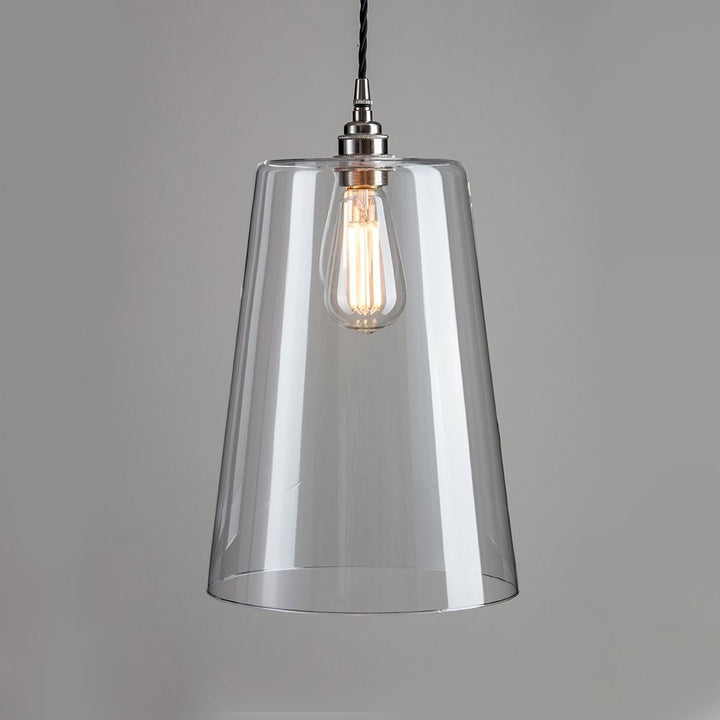 An Old School Electric Tapered Blown Glass Pendant Light with a light bulb hanging from it. This elegant lighting fixture serves as both a light fitting and an electric light, providing illuminating ambiance to any space.