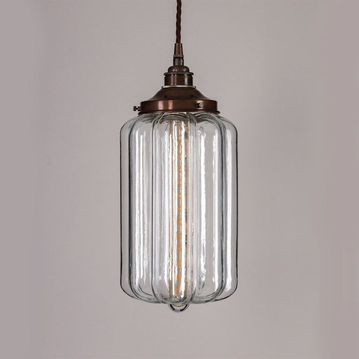 An Ellington Pendant Light by Old School Electric with a brass finish is a stunning addition to any space. This exquisite light fitting seamlessly combines elegance and functionality, bringing warmth and style to your room. The glass material creates a beautiful lighting effect.