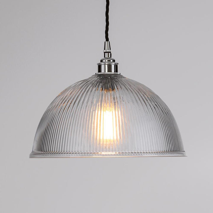 An Old School Electric Prismatic Dome Pendant Light is hanging from a ceiling.