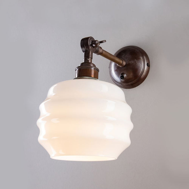 An Old School Electric Deco Opal Adjustable Arm Wall Light with a white glass shade.