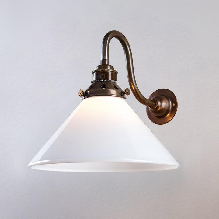 An Old School Electric Conical Bathroom Glass Wall Light on a white wall.