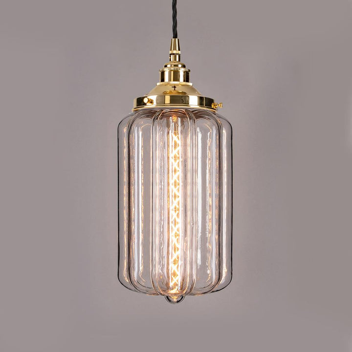 An Ellington Pendant Light by Old School Electric with a clear glass shade.