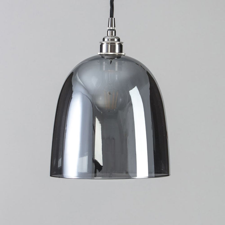 A Bell Blown Smoked Glass Pendant Light with a smoked glass shade from Old School Electric.