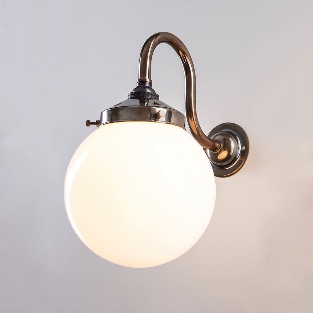 An Opal Globe Bathroom Wall Light fixture with a white globe on it from Old School Electric.