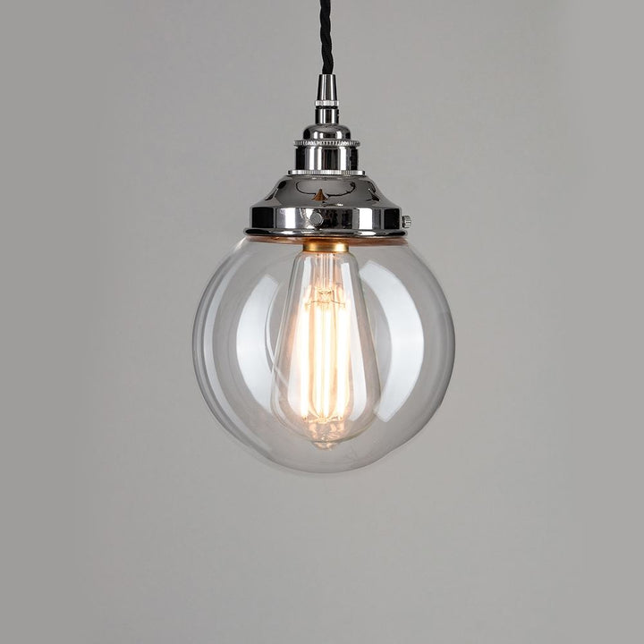 An Old School Electric Globe Blown Glass Pendant Light hanging from a chain on a white background.