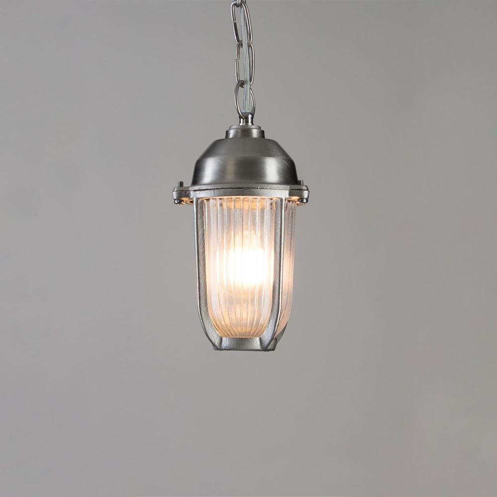 Bring maritime charm to your outdoor space with the Old School Electric Boatyard Pendant Light. This nautical-inspired fixture features a clear glass shade, illuminating your surroundings with style and elegance.