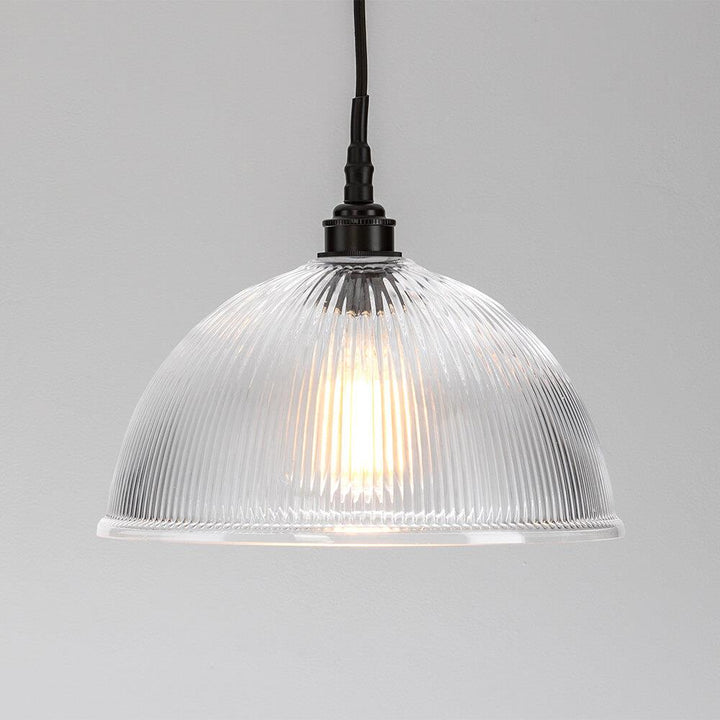 An Old School Electric Prismatic Dome Bathroom Pendant Light hanging on a white wall, providing stylish lighting fixtures.
