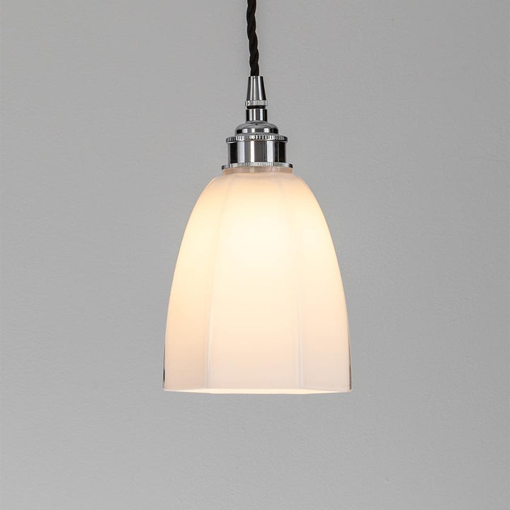 An Old School Electric Hexagon Pendant Light with a white glass shade. This electric light fitting showcases a sleek design, complemented by its pristine white glass shade.