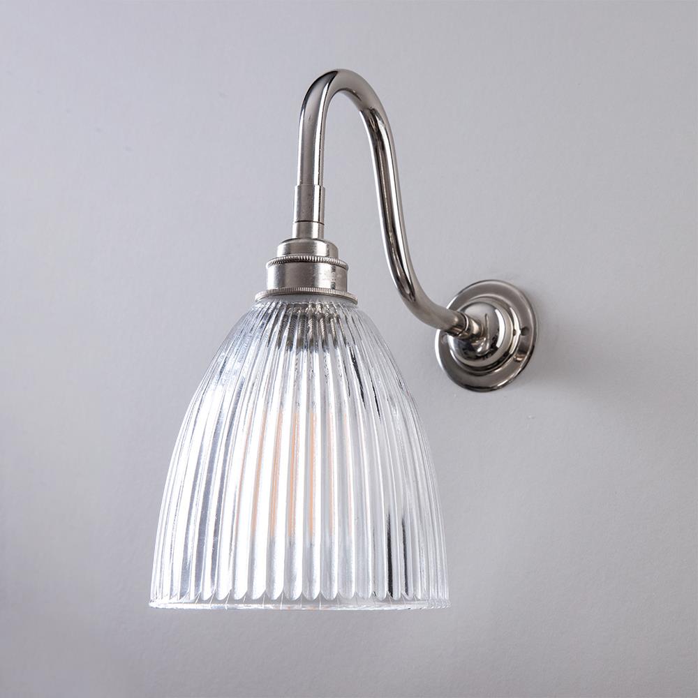 An Elongated Swan Arm Prismatic Bathroom Wall Light with a clear glass shade from Old School Electric.