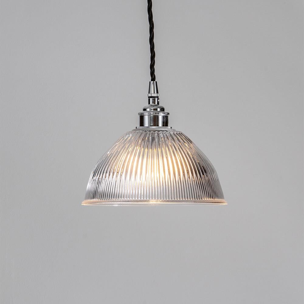 An Old School Electric Prismatic Dome Pendant Light fixture providing illumination from electric lights.