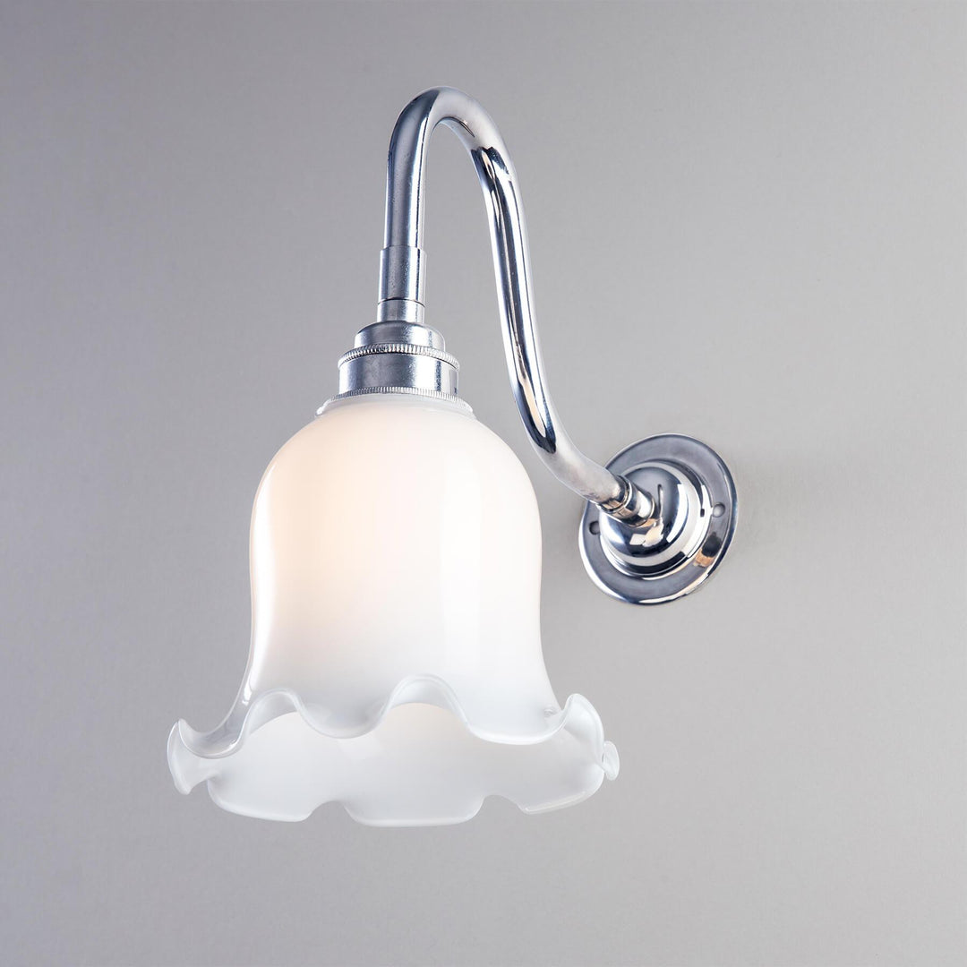 An Old School Electric Tulip Opal Glass Bathroom Wall Light adorned with a beautiful flower, serving as a light fitting.