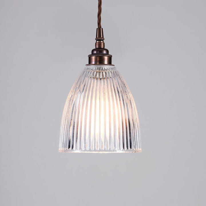 An Old School Electric Elongated Prismatic Pendant Light from a ceiling, providing elegant lighting.
