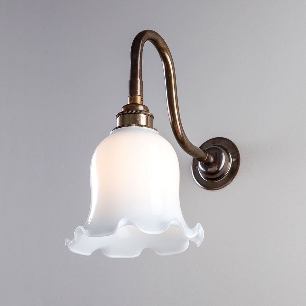 An Old School Electric Tulip Opal Glass Wall Light with a white glass shade.
