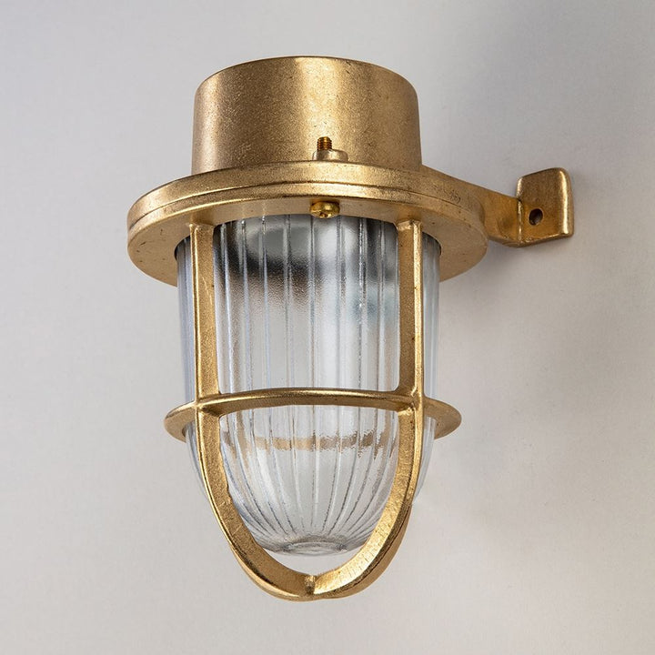 An Old School Electric Faros Mini Yacht Wall Light with a clear glass shade that serves as a perfect light fitting.