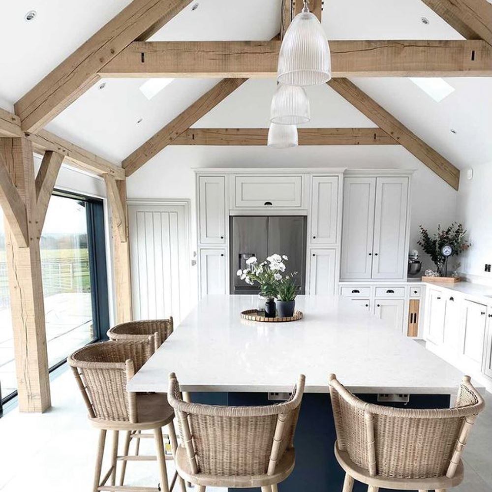A white kitchen with wooden beams and Old School Electric's Elongated Prismatic Pendant Light.