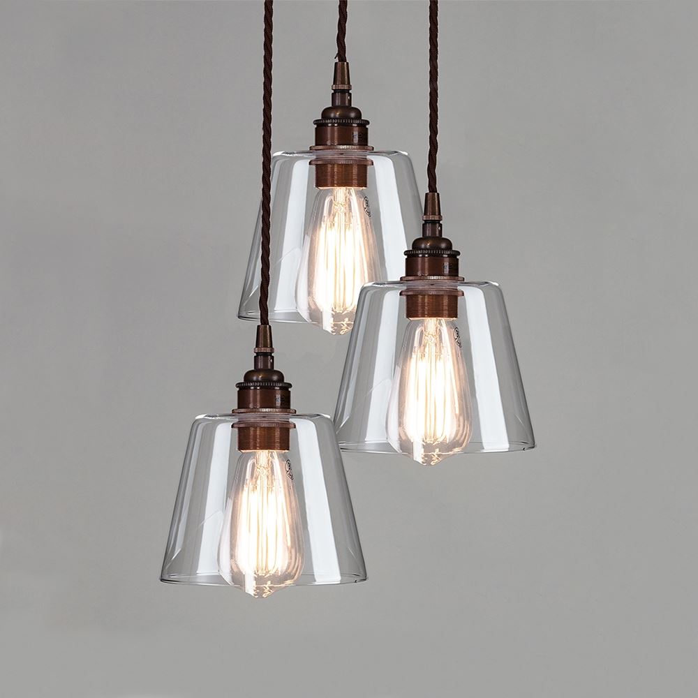 Three Blown Clear Glass Cluster Pendant Lights, also known as lighting fixtures, hanging from a ceiling. Brand: Old School Electric.