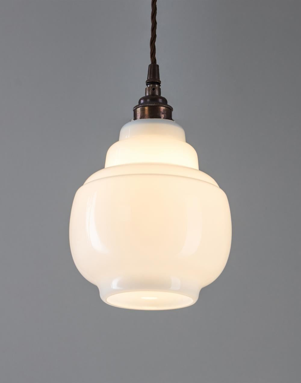 An Old School Electric Barrel Opal Glass Pendant Light fitting with a white shade and a brown cord.