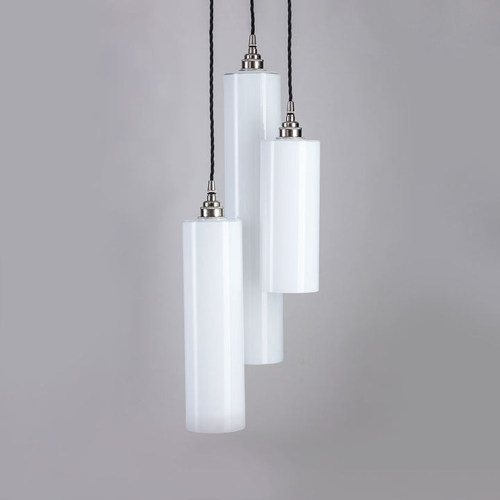 Three Parker Cluster Pendant Lights by Old School Electric hanging on a gray background.