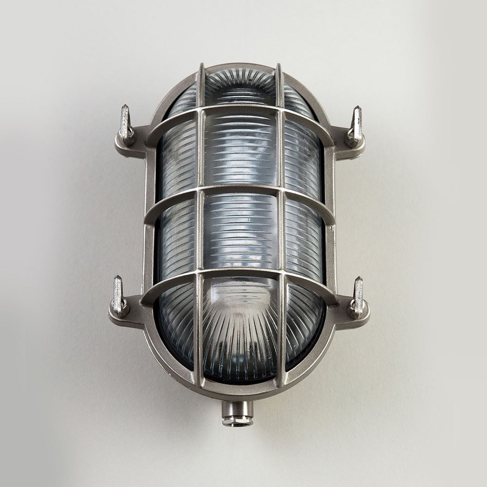 An Oval Bulkhead lighting fixture with wire mesh from Old School Electric.