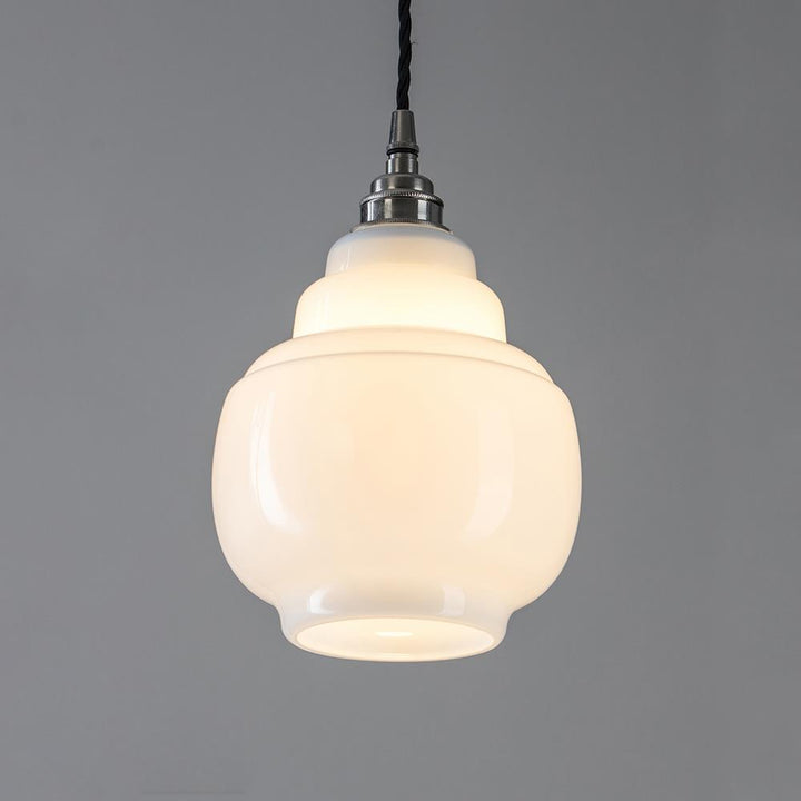 An Old School Electric Barrel Opal Glass Pendant Light with a white glass shade. This lighting fixture combines elegance and functionality, equipped with an electric light fitting.