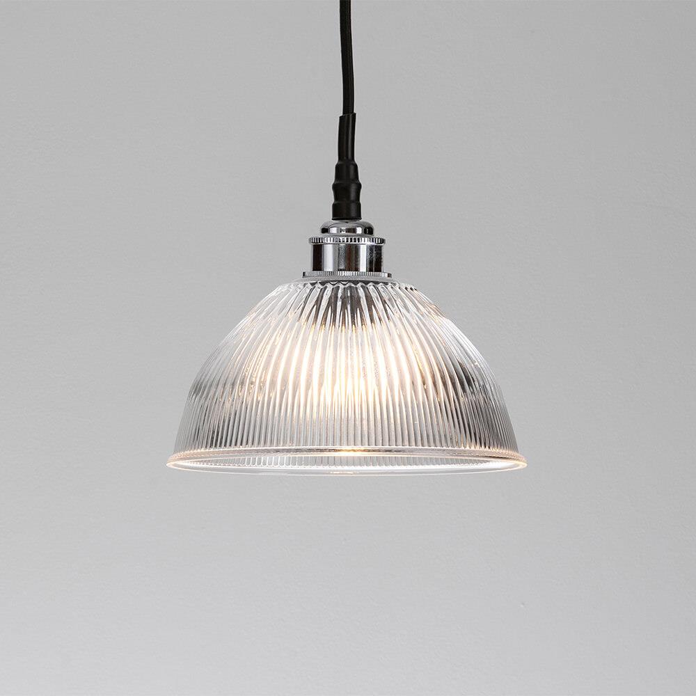An Old School Electric Prismatic Dome Bathroom Pendant Light, an elegant lighting fixture, hanging on a white wall.