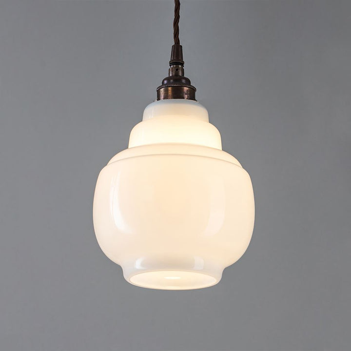 An Old School Electric Barrel Opal Glass Pendant Light with a brown cord, suitable for lighting fixtures.