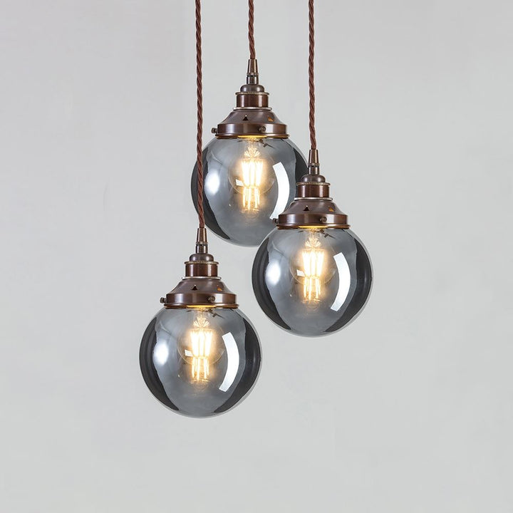 Three Old School Electric Blown Smoked Glass Cluster Pendant Light fixtures hanging from a chain.