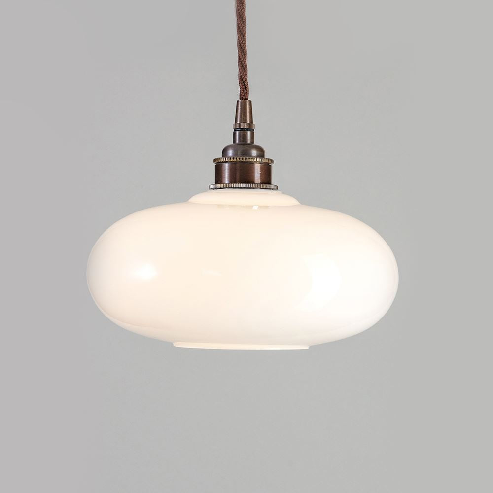An Old School Electric Montgomery Pendant Light with a brown cord.