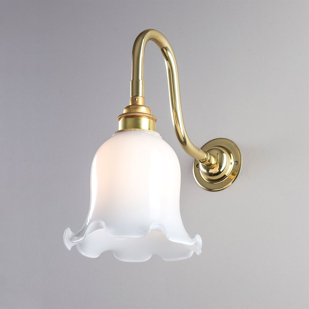 An Old School Electric brass Tulip Opal Glass wall light fixture with a white glass shade.