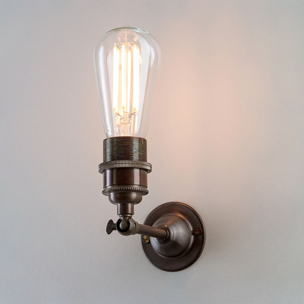 An Industrial Wall Light with a bulb on it from Old School Electric.