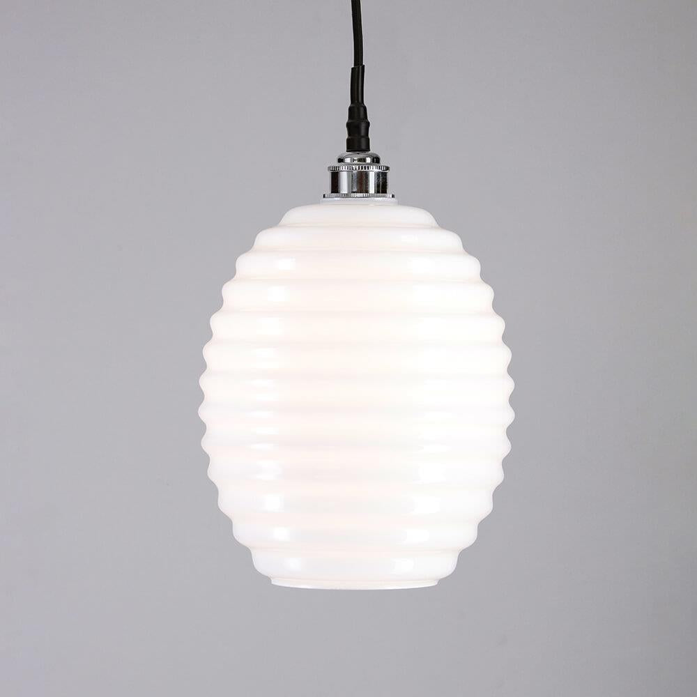 An Old School Electric Beehive Bathroom Pendant Light with a black cord.