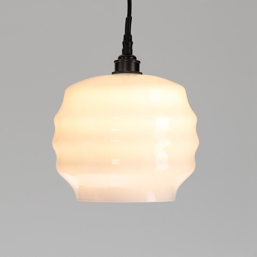 An Old School Electric Deco Bathroom Pendant Light, with a white glass shade, perfectly illuminating any space.