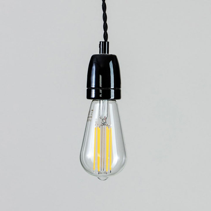 A Ceramic Cable Set suspended from a sleek black cord, designed by Old School Electric.