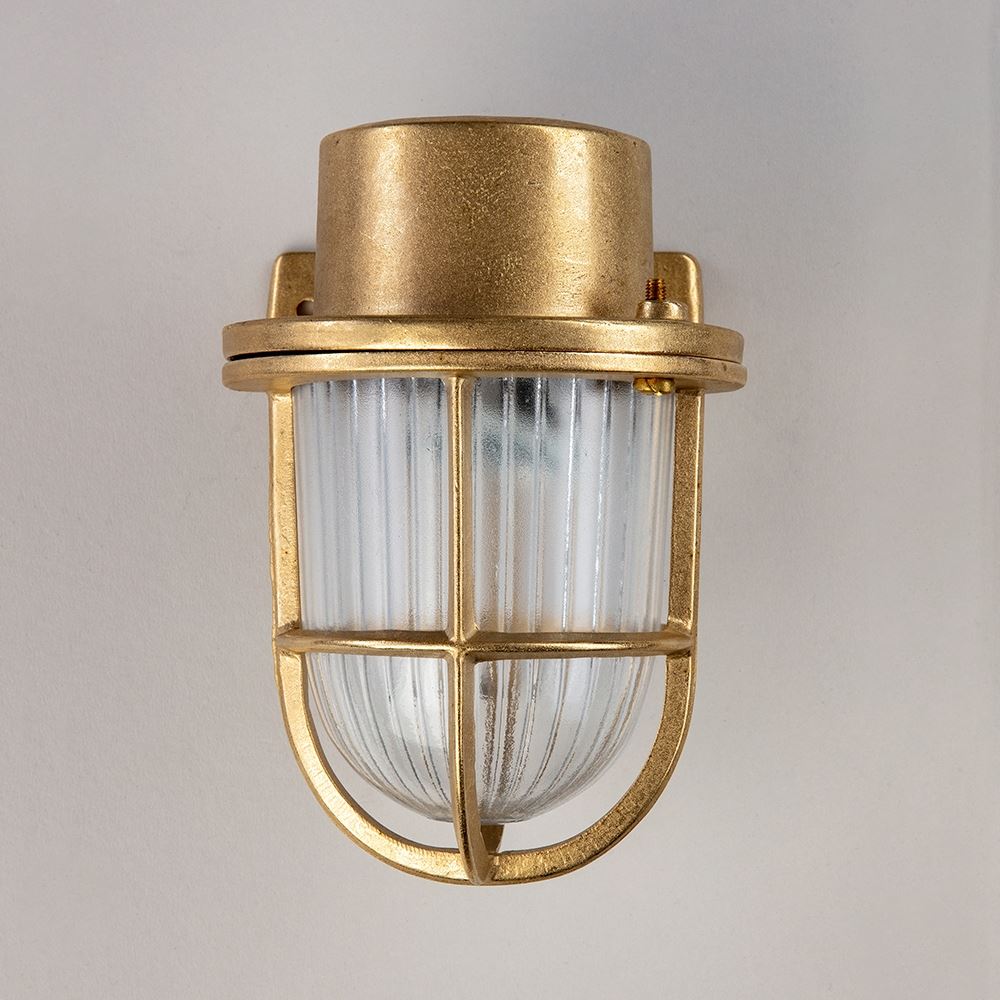 A Faros Mini Yacht Wall Light with a clear glass shade, serving as an elegant electric light fitting. (Brand: Old School Electric)