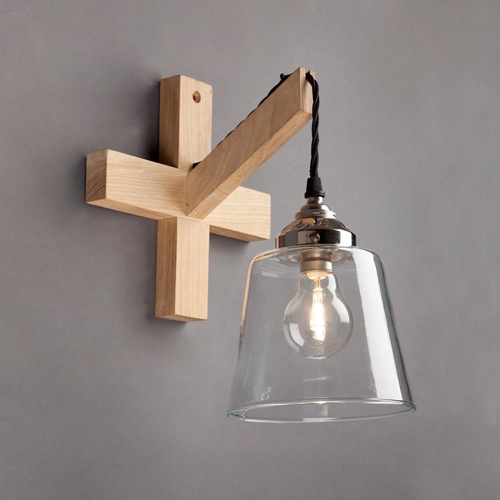 An Old School Electric Wooden Wall Bracket lighting fixture with a glass bulb.