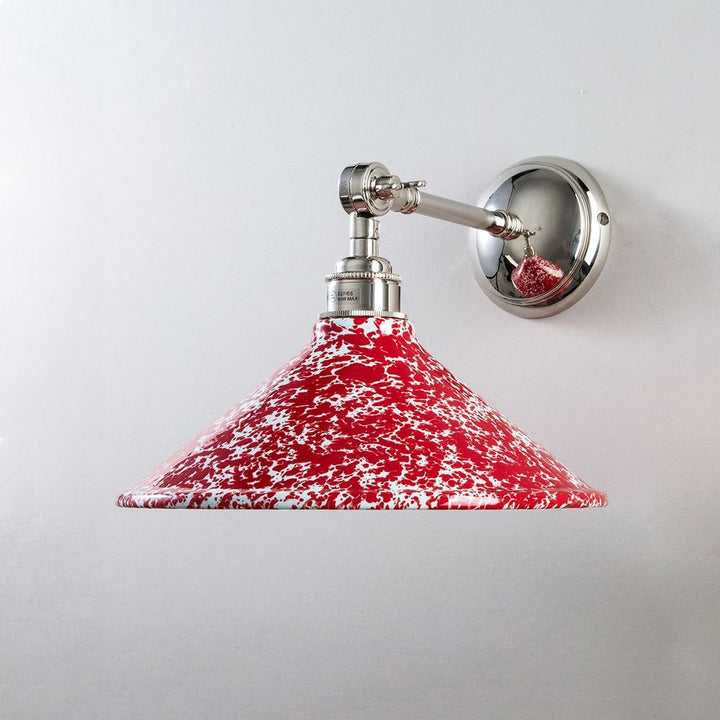 An Old School Electric Splatter Wear Shade Adjustable Arm Wall Light on a white wall.