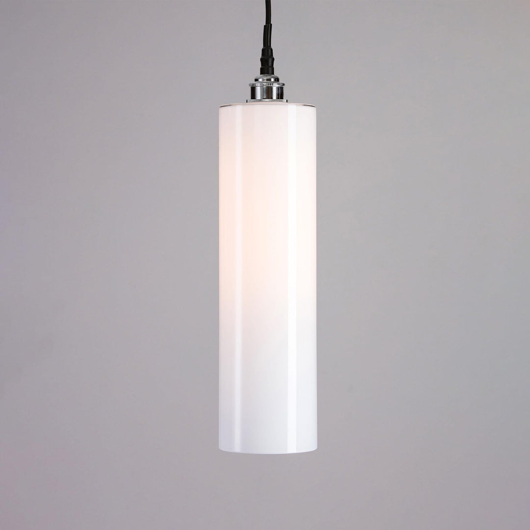 An Old School Electric Parker Bathroom Pendant Light illuminating the space with its soft glow, set against a cool gray background.