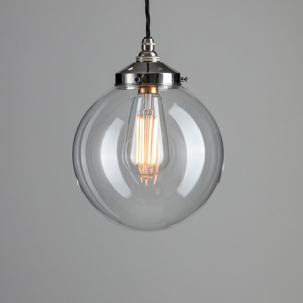 An Old School Electric Globe Blown Glass Pendant Light hanging from a metal chain. This elegant light fitting brings a touch of sophistication to any space with its sleek design and subtle illumination. The electric lights contained within the Old School Electric Globe Blown Glass Pendant Light (B22)