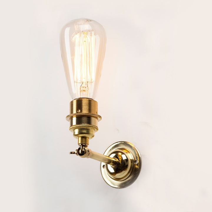 An Industrial Wall Light from Old School Electric with a bulb on it.