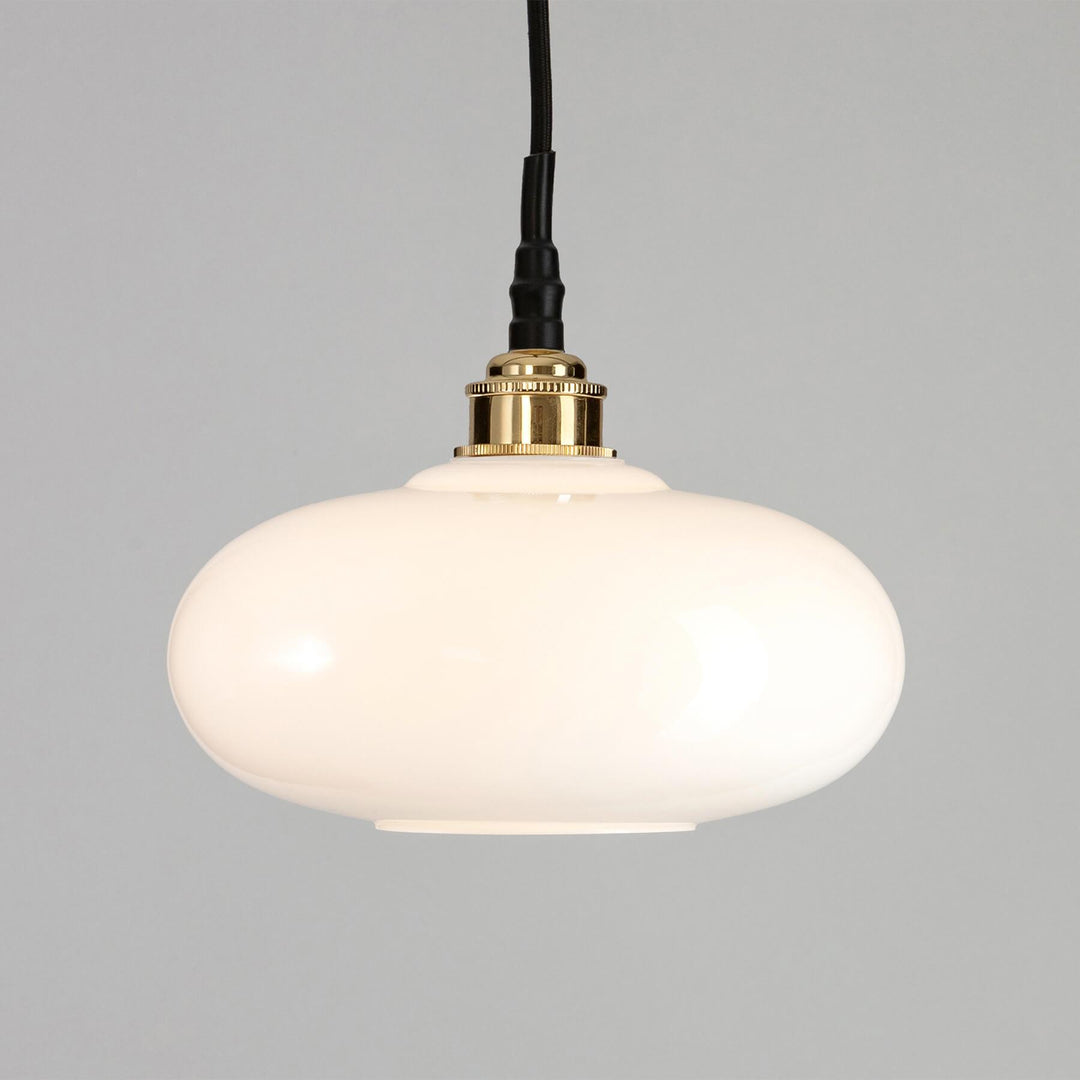 An Old School Electric Montgomery Bathroom Pendant Light with a brass finish.