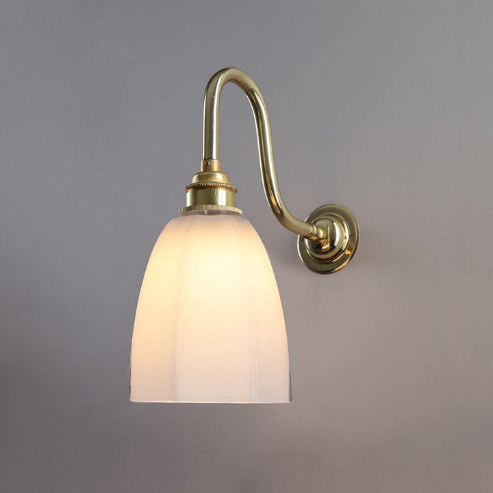 An Old School Electric Hexagon Swan Wall Light with a white glass shade.