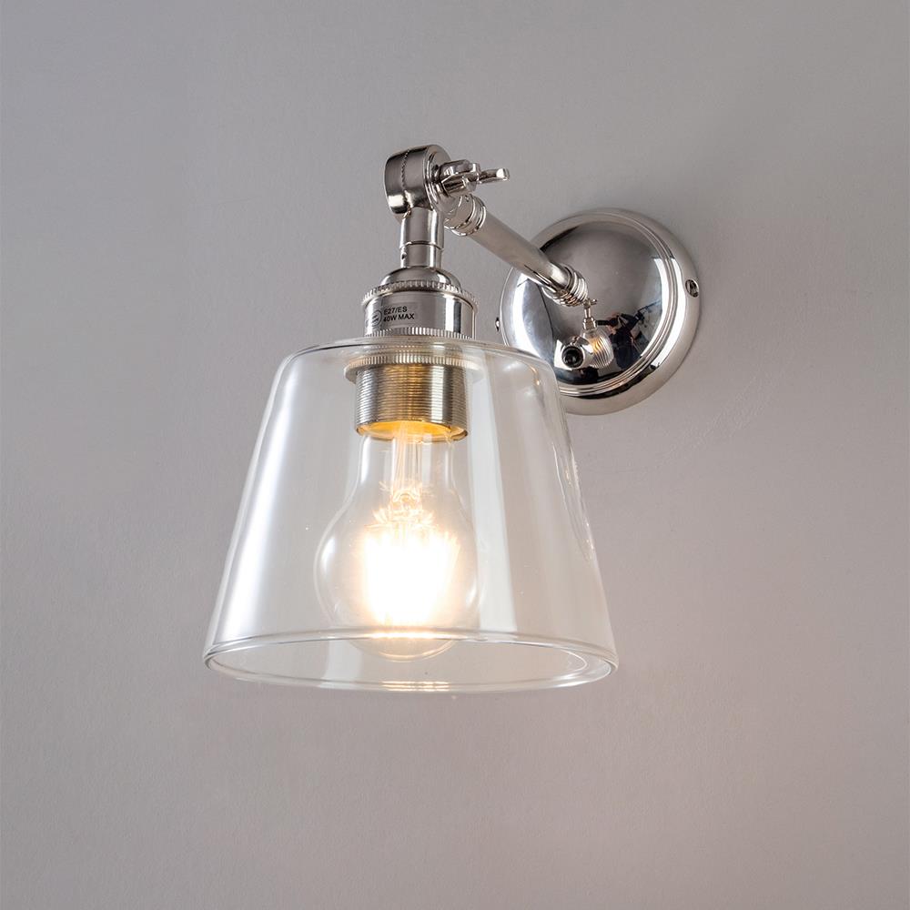 An Old School Electric Glass Adjustable Arm Wall Light with a glass shade on a white wall.