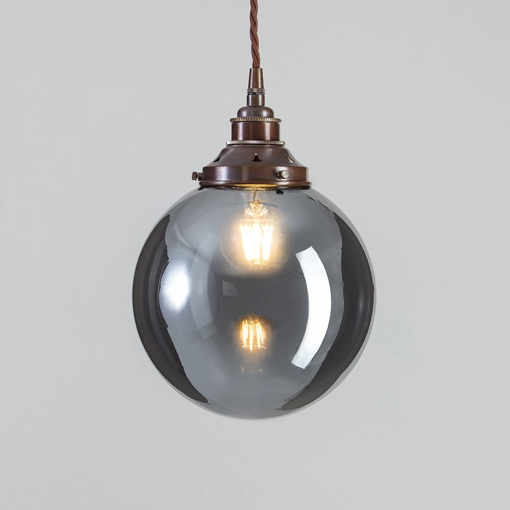 An Old School Electric pendant light fitting with a black shade and a brown cord, the Globe Blown Smoked Glass Pendant Light.