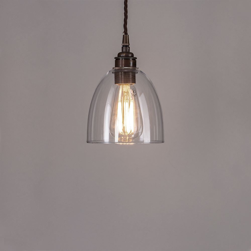 An Old School Electric Bell Blown Glass Pendant Light with a metal chain, perfect for adding elegance to any space. Expertly crafted, this light fitting effortlessly combines modern design with durability. Illuminate your space with the soft lighting provided by the Bell Blown Glass Pendant Light from Old School Electric.