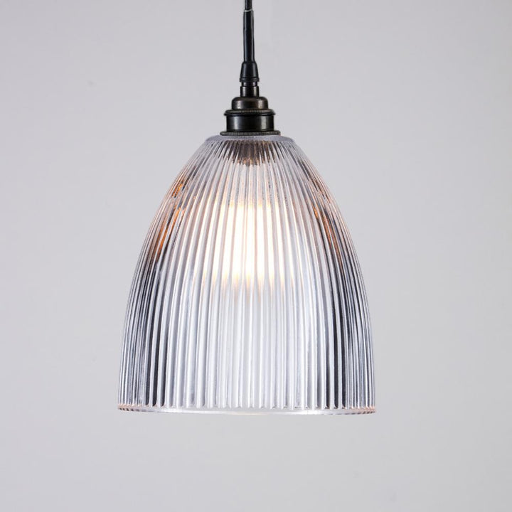 An Elongated Prismatic Bathroom Pendant Light fixture with a clear glass shade from Old School Electric.