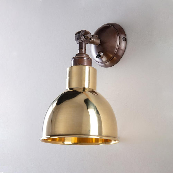 An Old School Electric Churchill Short Arm Wall Light on a white wall.